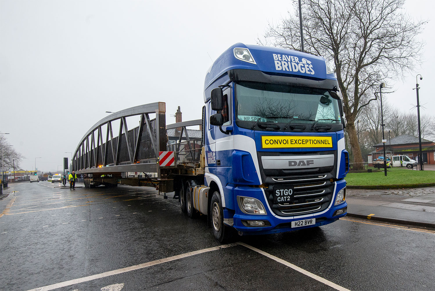 Beaver Bridges lorry carrying a large bridge is being escorted through town | Beaver Bridges